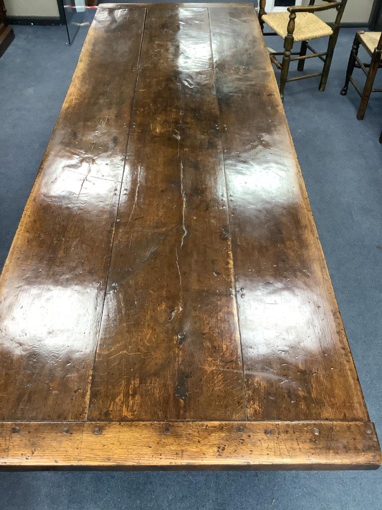 An 18th century style oak refectory dining table, length 274cm, width 94cm, height 72cm